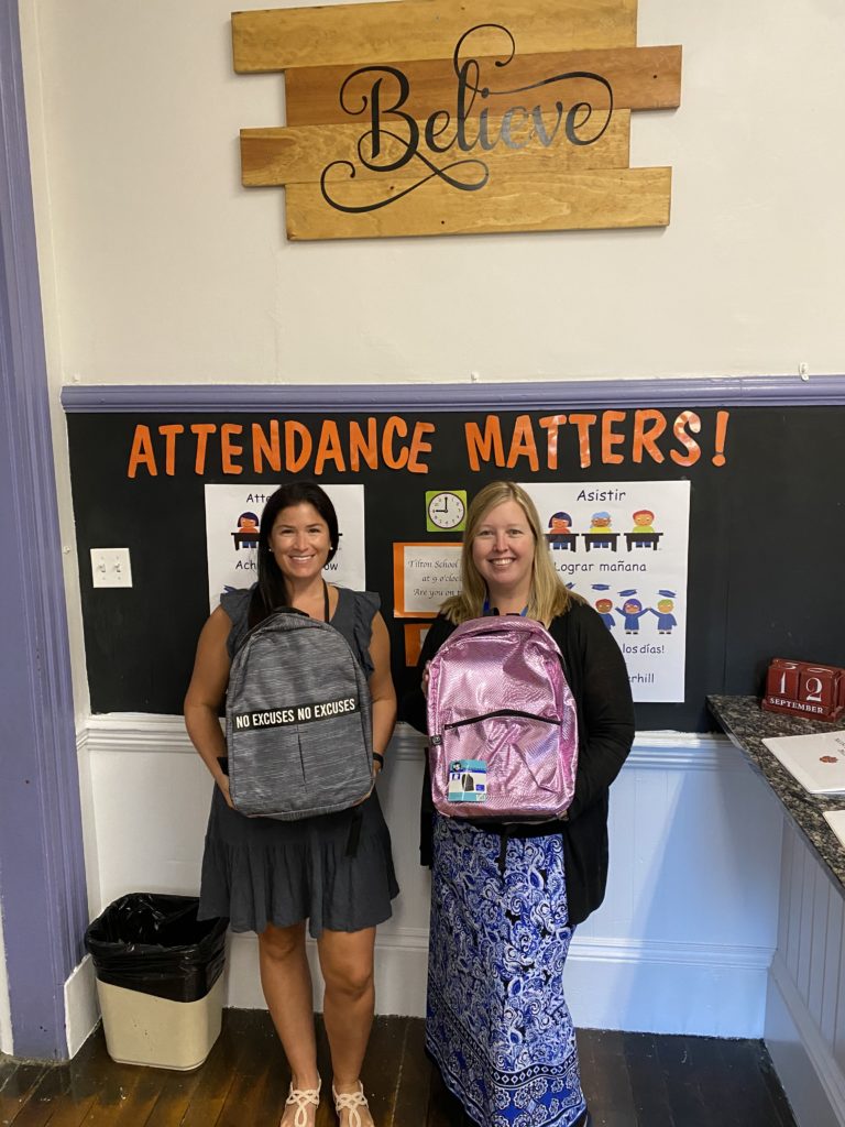 Ms. Chastney and Mrs. Mackay display donated backpacks from the Knights of Columbus.